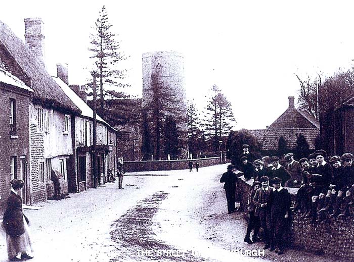 Historic photograph of The Street in Great Ryburgh showing the village and round tower church